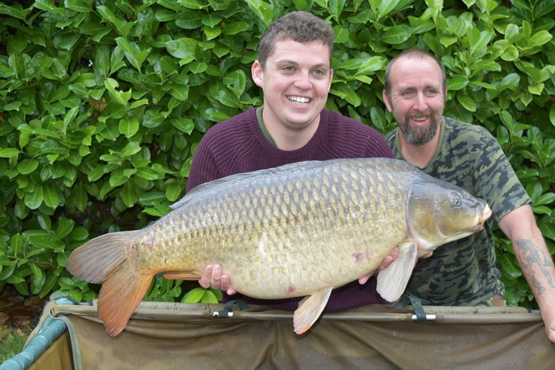 John Furnley with a 37-12 Common caught from the Cottage swim, held by Luke Williams