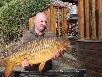 Dave with a 23-08 Mirror Carp from Cherry Lake. He has the best job in the world!.jpg