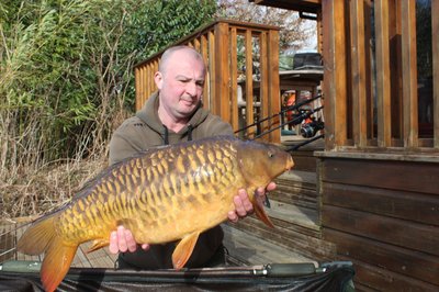 Dave with a 23-08 Mirror Carp from Cherry Lake. He has the best job in the world!.jpg