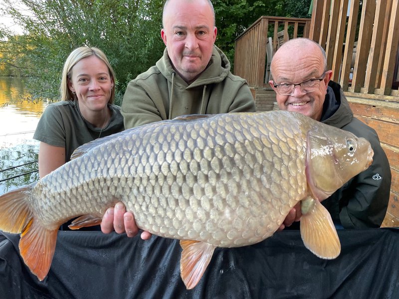 Stacey Morris and Brian Poole with their 30-08 Common held by fishery manager Dave.