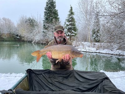 Dale Green with a 'Snow Carp', a Common of 21lb from Cherry Mere