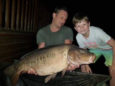 Matt Howgate aided by son Luke, with a 28-04 Mirror from Osprey Lodge
