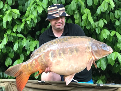 Matthew Blinston with 'The Peach', a stunning Ghost Mirror Carp of 31-14.