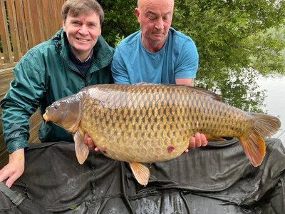 Peter Callow with his 45-12 Common known as 'The Scuff', presented with him by fishery manager Dave.s . 45-12 L.jpg